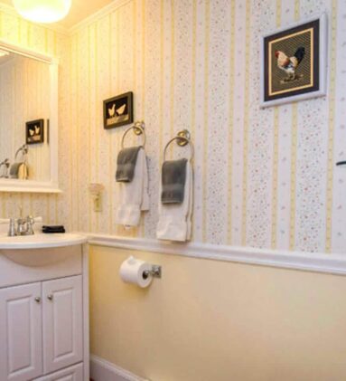 bathroom with yellow and white wallpaper