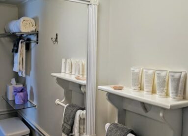 bathroom with shelf in front of mirror